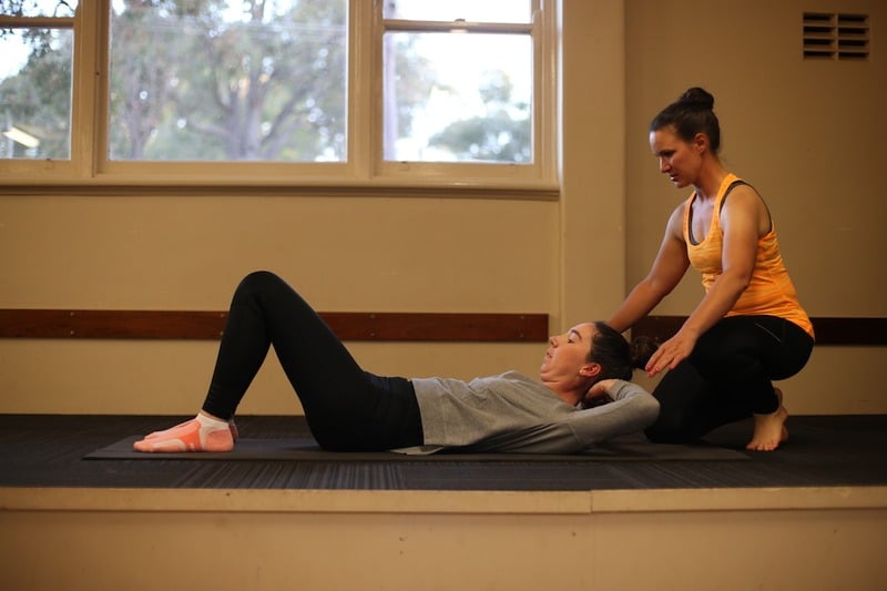 Katrin guiding an individual Pilates session on a mat